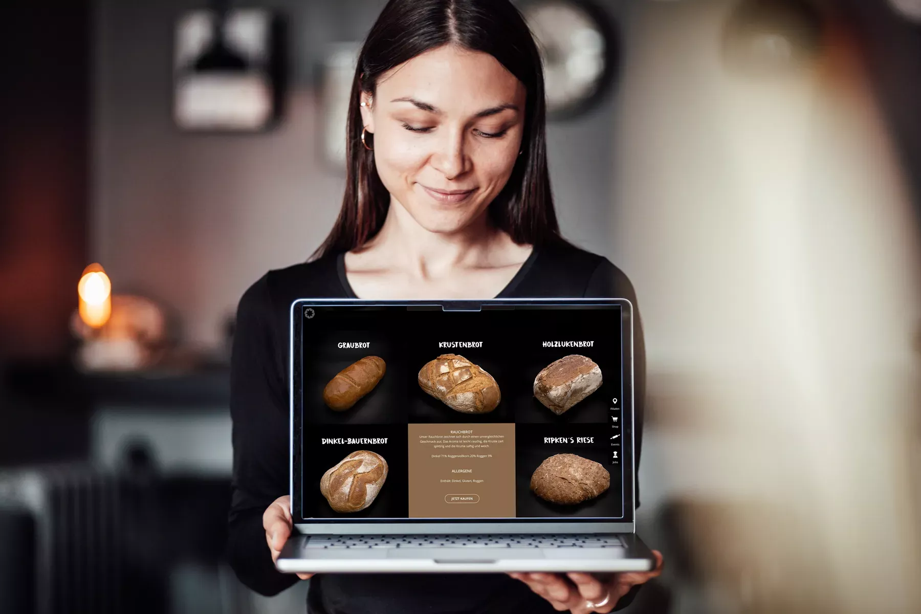 Eine Frau hält einen Laptop mit der neu entwickelten Website der Holzofenbäckerei Ripken, die BICEPS als Werbeagentur aus Braunschweig mit Webdesign und WooCommerce-Online-Shop umgesetzt hat.